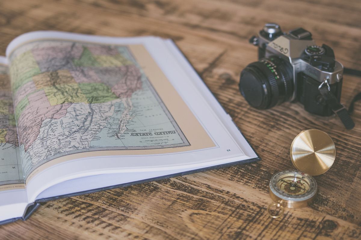 compass-with-map-on-table-camera-travel